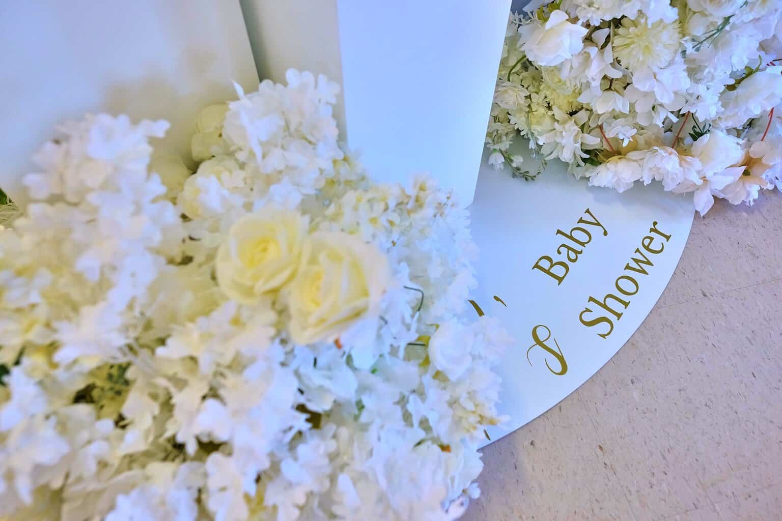 Elegant baby shower centerpiece with candles and coordinated linens