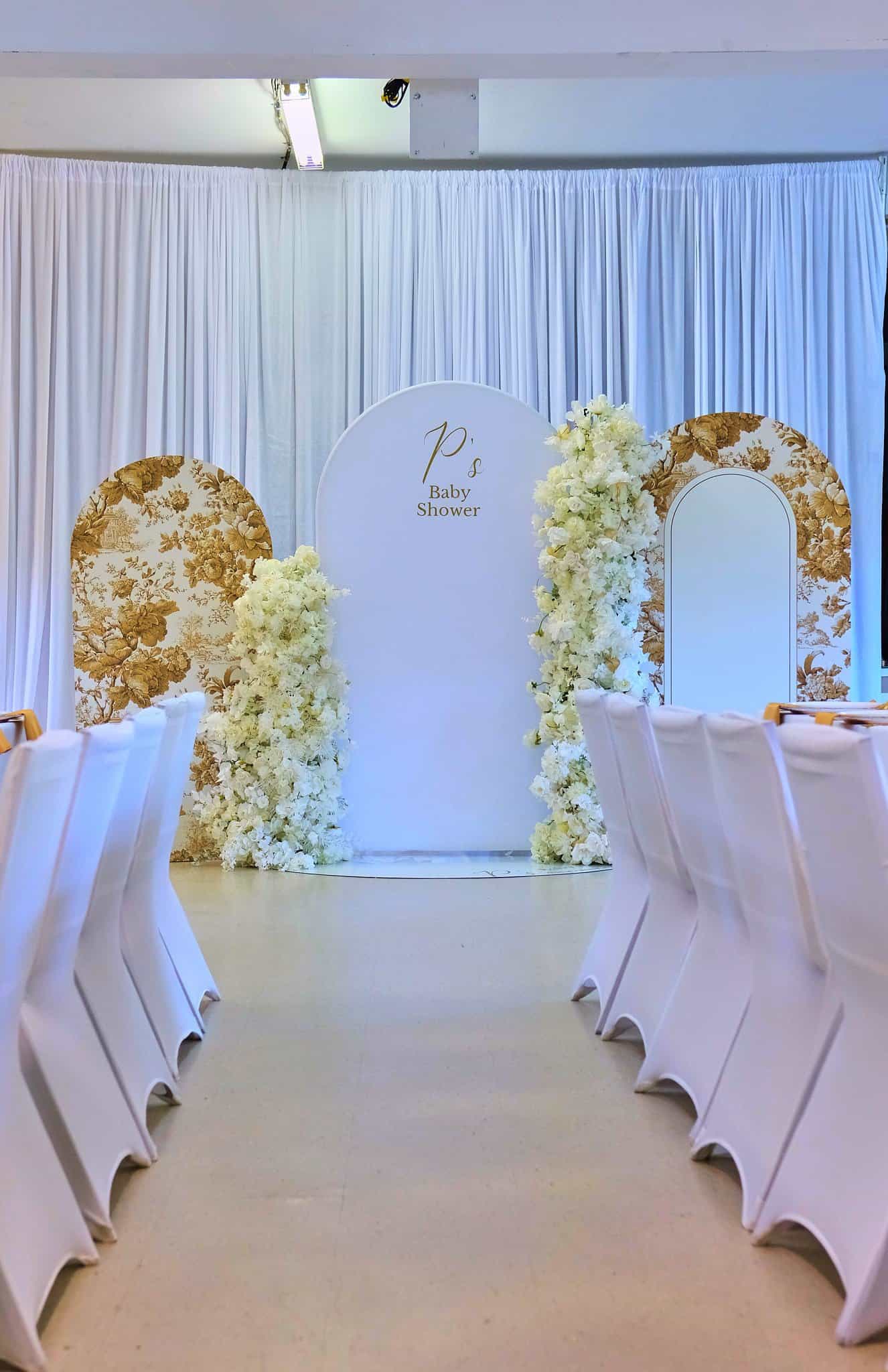 Baby shower centerpiece with lush blooms and candlelight accents