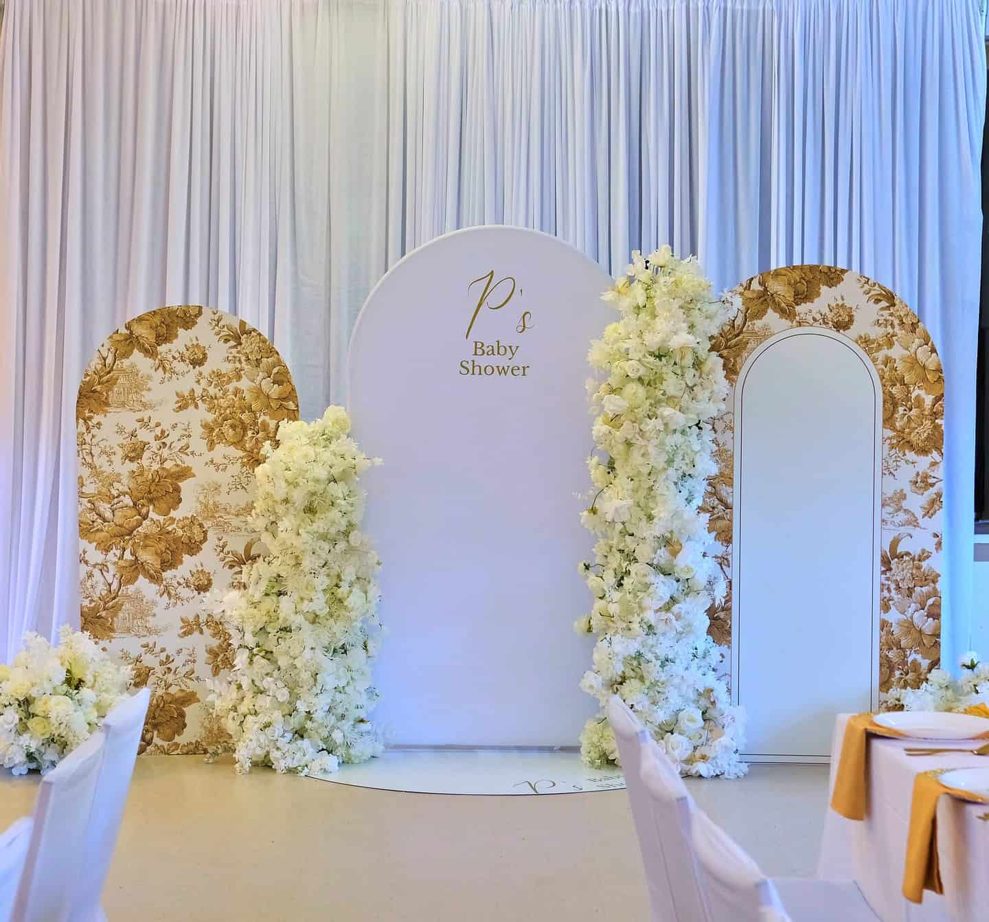 Elegant baby shower table setup with coordinated linens and floral details