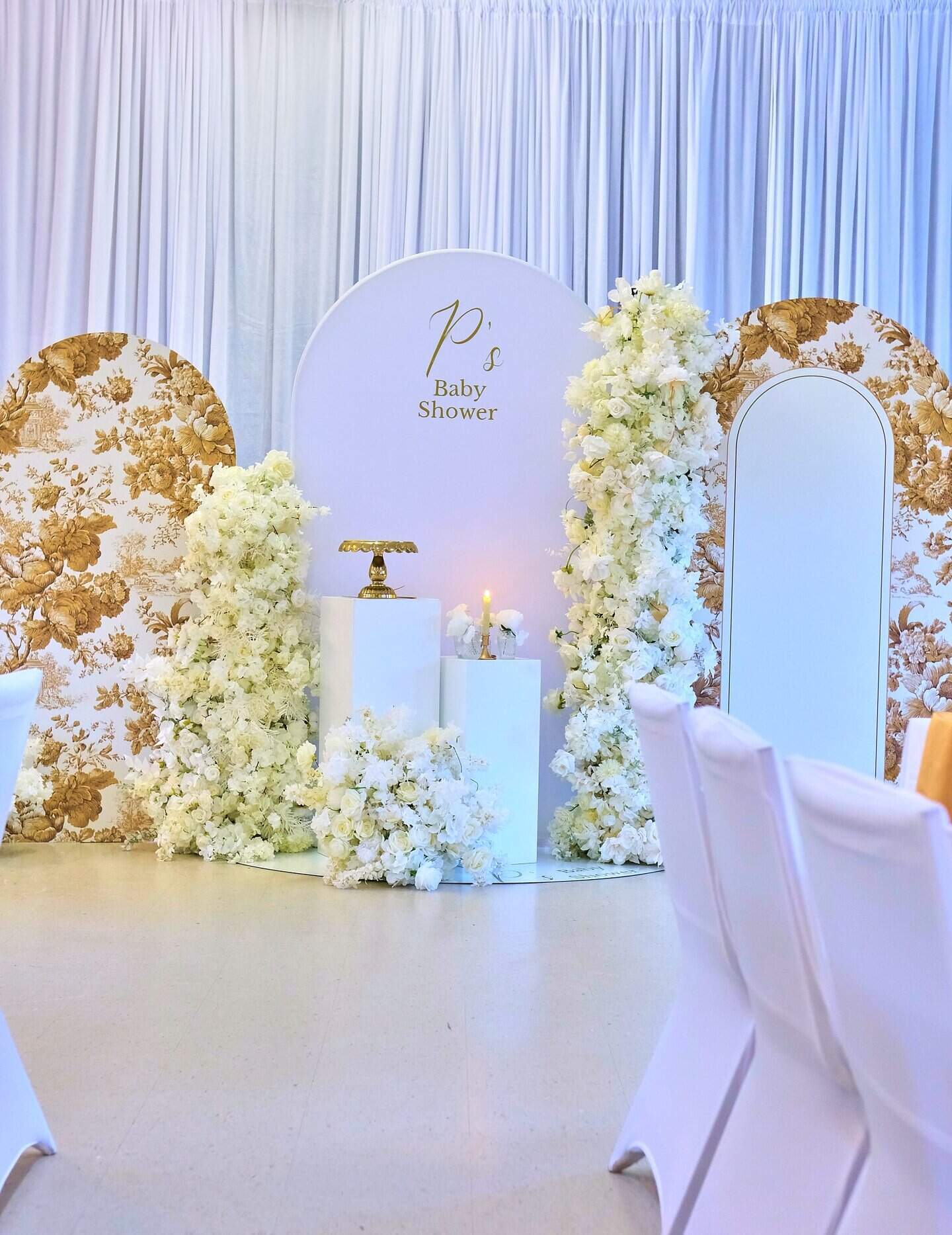 Romantic baby shower centerpiece with floral blooms and candle accents