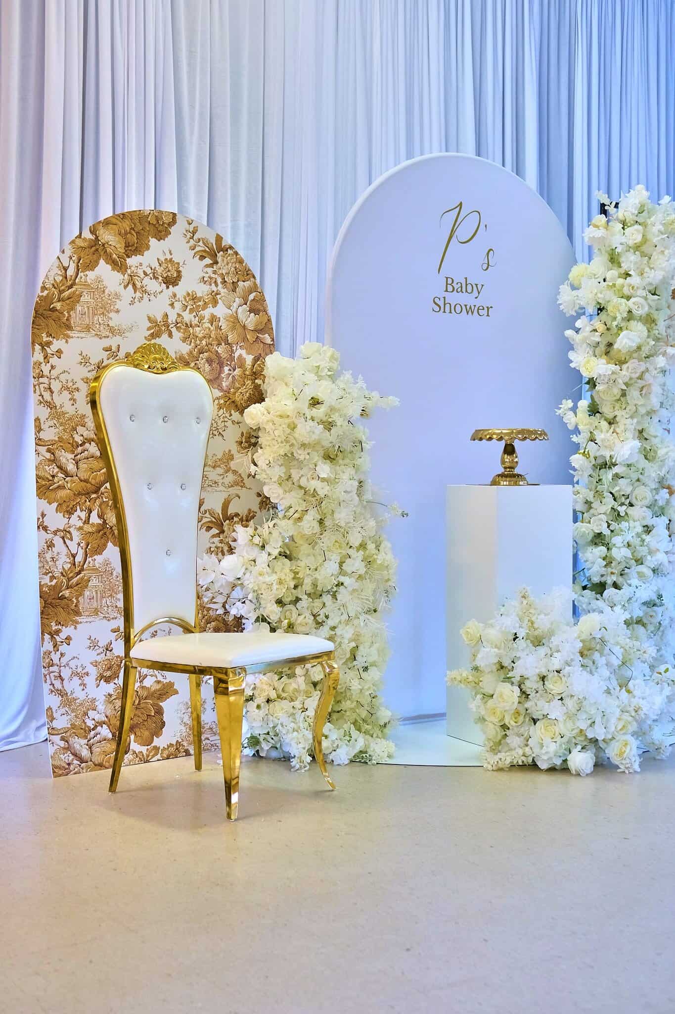 Elegant baby shower table arrangement with refined linens and greenery