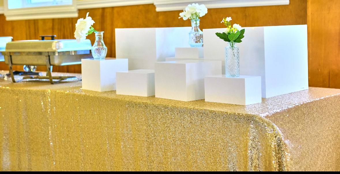 Cozy baby shower reception setup with draped linens and centerpiece