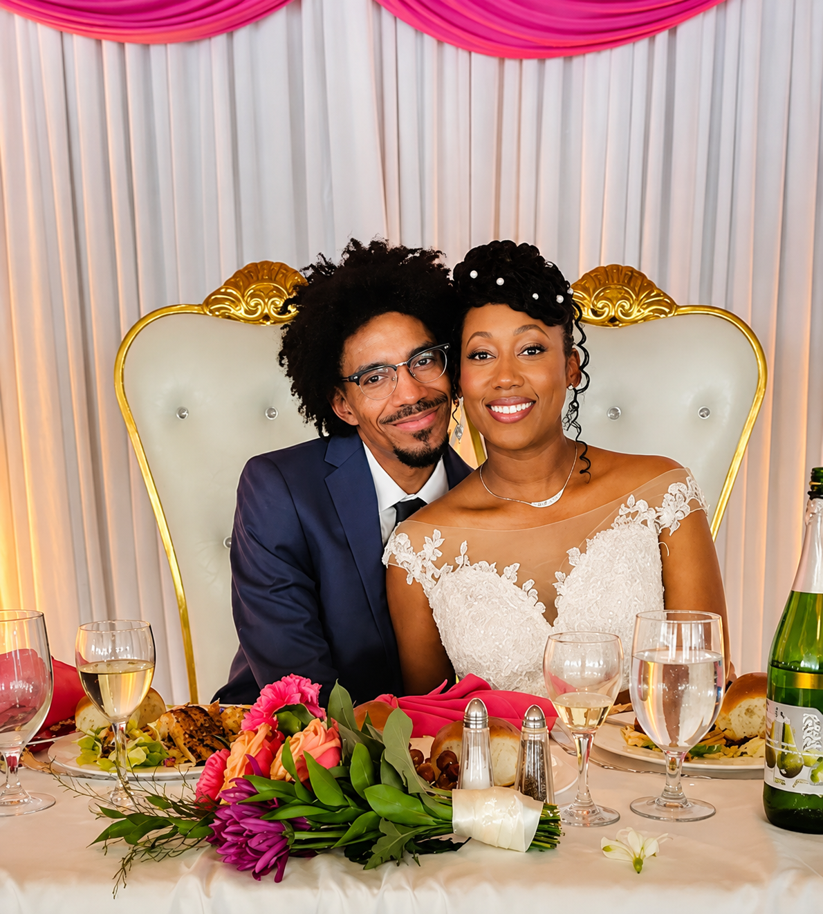 Jessica and De'Marco smiling together at their sweetheart table at St. Mary's Boat Club in Halifax